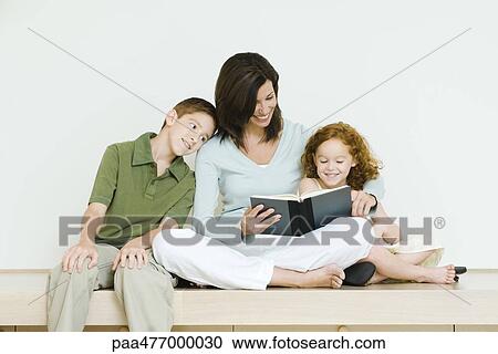 Mother reading book to son and daughter View Large Photo Image Stock Image - Mother reading book to son and daughter. Fotosearch