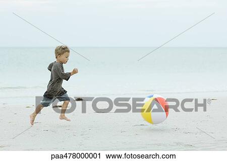 Little boy running after ball on beach View Large Photo Image Stock Image - Little boy running after ball on beach. Fotosearch
