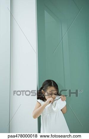 Stock Photo - Little girl looking into purse. Fotosearch
