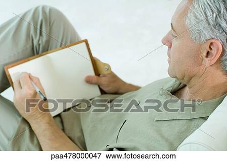 Mature man writing in diary View Large Photo Image Stock Photo - Mature man writing in diary. Fotosearch