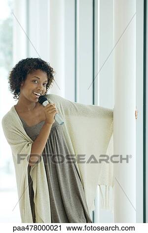 Young woman singing with microphone View Large Photo Image Stock Image - Young woman singing with microphone. Fotosearch