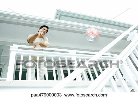 Man throwing drink can from deck, low angle view View Large Photo Image Stock Image - Man throwing drink can from deck, low angle view. Fotosearch
