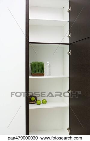 Sparse pantry containing apples in nest, tray of wheat grass and bottle of water View Large Photo Image Stock Image - Sparse pantry containing apples in nest, tray of wheat grass and bottle of water. Fotosearch