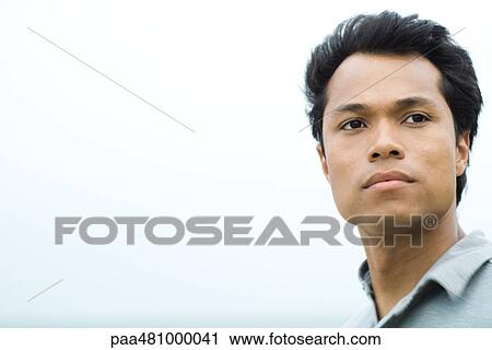 Stock Image - Man looking away, cropped portrait. Fotosearch