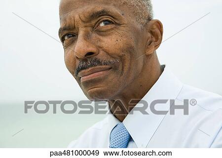 Senior man looking up, smiling, cropped portrait View Large Photo Image Stock Photo - Senior man looking up, smiling, cropped portrait. Fotosearch