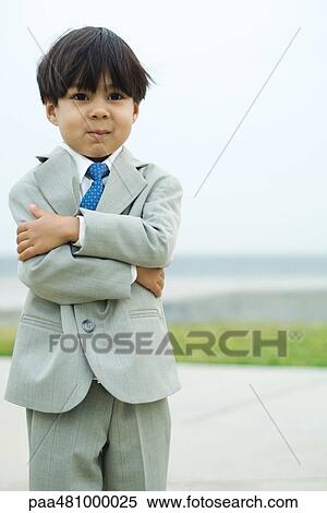 Young boy dressed in suit, arms folded, smiling, portrait View Large Photo Image Stock Photography - Young boy dressed in suit, arms folded, smiling, portrait. Fotosearch