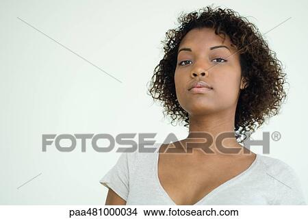 Young woman looking at camera, portrait View Large Photo Image Picture - Young woman looking at camera, portrait. Fotosearch