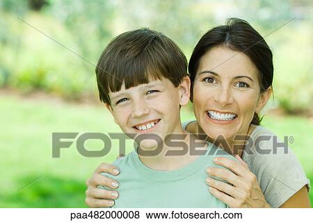 Mother and son smiling at camera together, portrait View Large Photo Image Stock Photo - Mother and son smiling at camera together, portrait. Fotosearch