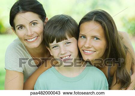 Mother with teenage daughter and son, all smiling at camera, portrait View Large Photo Image Stock Image - Mother with teenage daughter and son, all smiling at camera, portrait. Fotosearch