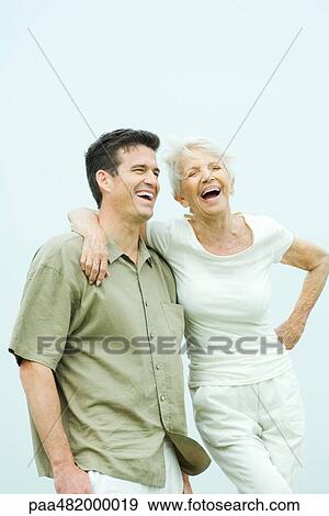 Senior woman standing with arm around adult son's shoulder, both smiling View Large Photo Image Stock Photo - Senior woman standing with arm around adult son's shoulder, both smiling. Fotosearch