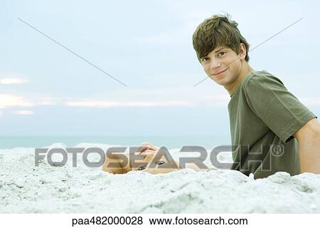 Stock Photo - Two brothers at the beach, both smiling at camera. Fotosearch