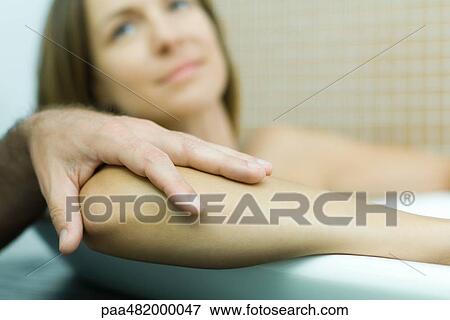 Woman in bathtub with man's hand on her elbow, focus on foreground, cropped view View Large Photo Image Stock Photo - Woman in bathtub with man's hand on her elbow, focus on foreground, cropped view. Fotosearch