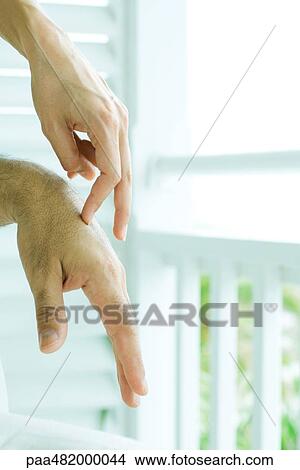 Picture - Woman touching man's hands with fingers, cropped view, close-up. Fotosearch