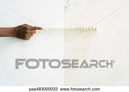 Child reaching toward lined up dominoes, cropped view of hand View Large Photo Image Stock Image - Child reaching toward lined up dominoes, cropped view of hand. Fotosearch
