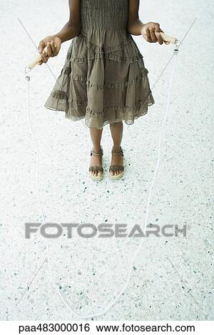 Girl holding jump rope, cropped view View Large Photo Image Stock Photograph - Girl holding jump rope, cropped view. Fotosearch