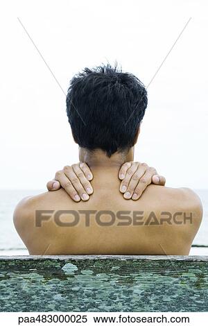 Man with hands on his shoulders, rear view View Large Photo Image Stock Photography - Man with hands on his shoulders, rear view. Fotosearch