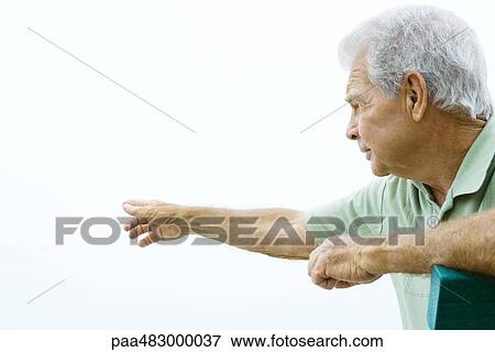 Senior man pointing, looking away, side view View Large Photo Image Stock Photo - Senior man pointing, looking away, side view. Fotosearch