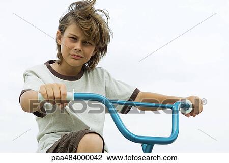 Boy on bicycle, looking at camera, portrait View Large Photo Image Stock Image - Boy on bicycle, looking at camera, portrait. Fotosearch