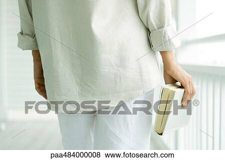 Person carrying book, cropped rear view View Large Photo Image Stock Photo - Person carrying book, cropped rear view. Fotosearch