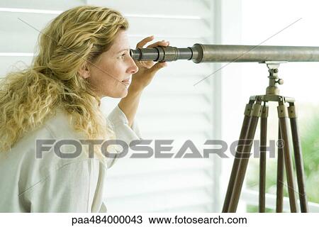 Woman looking through telescope, side view View Large Photo Image Stock Image - Woman looking through telescope, side view. Fotosearch