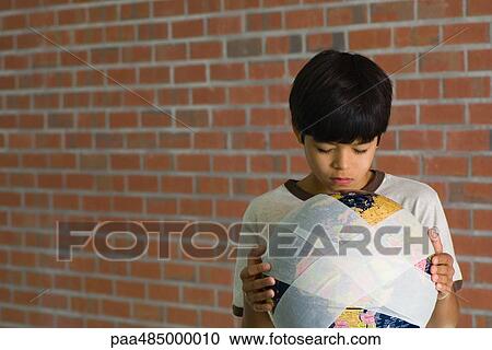 Boy holding bandaged globe, front view View Large Photo Image Stock Image - Boy holding bandaged globe, front view. Fotosearch