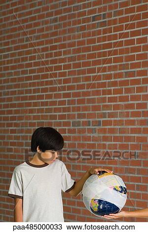 Boy taking bandaged globe from outstretched hand View Large Photo Image Stock Image - Boy taking bandaged globe from outstretched hand. Fotosearch