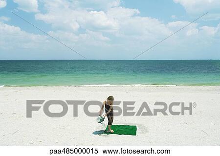 Girl watering square of artificial turf on beach, high angle view View Large Photo Image Stock Photography - Girl watering square of artificial turf on beach, high angle view. Fotosearch
