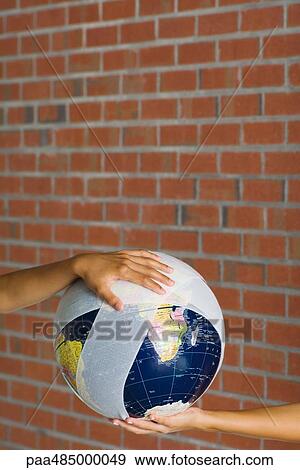 Hands holding a bandaged globe View Large Photo Image Stock Photo - Hands holding a bandaged globe. Fotosearch