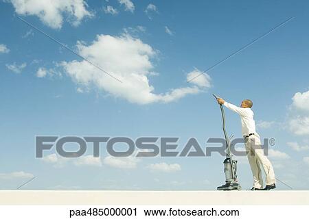 Man vacuuming sky View Large Photo Image Stock Image - Man vacuuming sky. Fotosearch