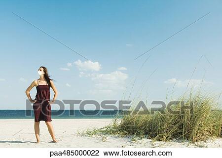 Woman standing on beach, wearing pollution mask View Large Photo Image Stock Image - Woman standing on beach, wearing pollution mask. Fotosearch
