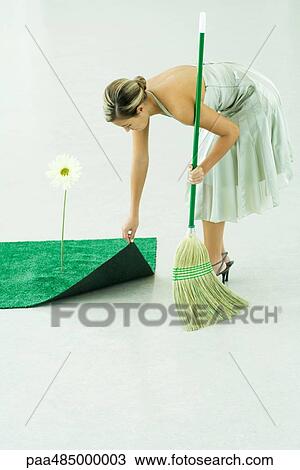 Woman sweeping under rug of artificial turf View Large Photo Image Stock Image - Woman sweeping under rug of artificial turf. Fotosearch