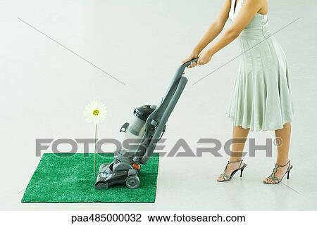 Woman vacuuming square of artificial turf, chest down View Large Photo Image Stock Image - Woman vacuuming square of artificial turf, chest down. Fotosearch
