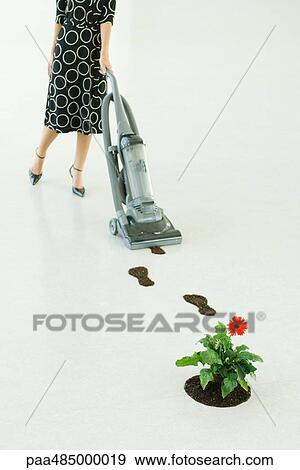 Woman vacuuming up footprints of soil, low section View Large Photo Image Stock Photo - Woman vacuuming up footprints of soil, low section. Fotosearch