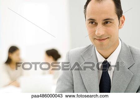 Businessman looking away, smiling, close-up View Large Photo Image Stock Image - Businessman looking away, smiling, close-up. Fotosearch