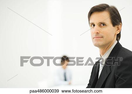 Stock Photo - Businessman smiling at camera, portrait. Fotosearch