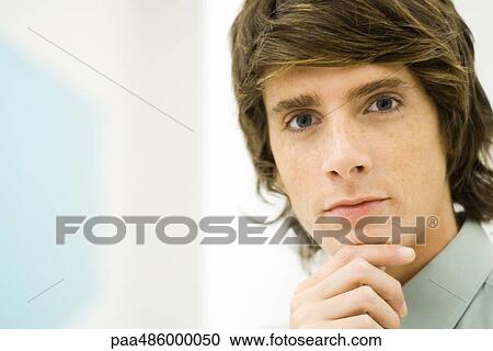 Stock Image - Male looking at camera, portrait, close-up. Fotosearch