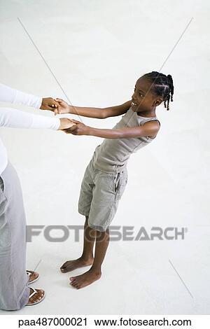 Little girl holding mother's hands, leaning back, cropped view View Large Photo Image Stock Image - Little girl holding mother's hands, leaning back, cropped view. Fotosearch