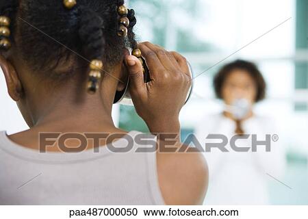 Little girl holding tin can phone up to ear, close-up, rear view View Large Photo Image Stock Image - Little girl holding tin can phone up to ear, close-up, rear view. Fotosearch
