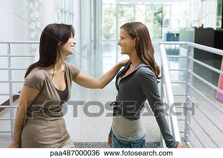 Mother and daughter standing face to face on stairs, both smiling at each other View Large Photo Image Stock Photograph - Mother and daughter standing face to face on stairs, both smiling at each other. Fotosearch