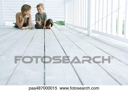 Mother and son on porch together, smiling at each other, boy holding butterfly, low angle view View Large Photo Image Stock Photography - Mother and son on porch together, smiling at each other, boy holding butterfly, low angle view. Fotosearch