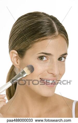 Woman applying blush, smiling at camera, close-up View Large Photo Image Stock Image - Woman applying blush, smiling at camera, close-up. Fotosearch