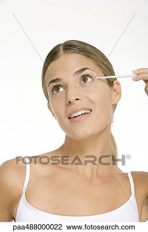 Woman applying eye make-up View Large Photo Image Stock Image - Woman applying eye make-up. Fotosearch