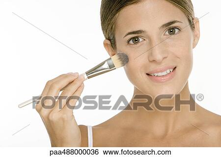 Woman applying make-up View Large Photo Image Stock Photograph - Woman applying make-up. Fotosearch