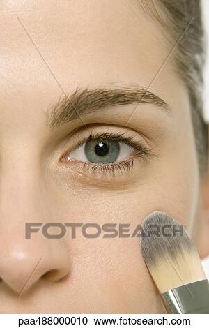 Woman applying make-up to cheek, cropped view of face View Large Photo Image Stock Image - Woman applying make-up to cheek, cropped view of face. Fotosearch