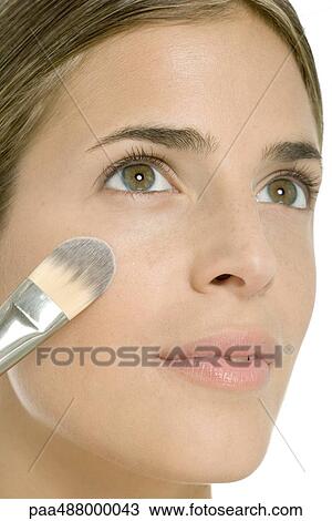Woman putting on blush, close-up of face View Large Photo Image Stock Image - Woman putting on blush, close-up of face. Fotosearch