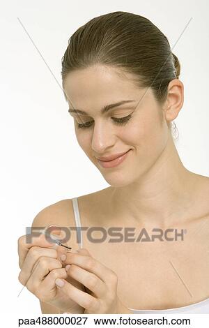 Woman putting on nail polish View Large Photo Image Stock Photo - Woman putting on nail polish. Fotosearch