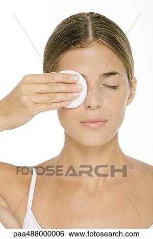 Stock Photograph - Woman removing eye make-up. Fotosearch