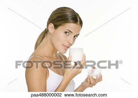 Woman smelling jar of moisurizer, looking at camera View Large Photo Image Stock Image - Woman smelling jar of moisurizer, looking at camera. Fotosearch