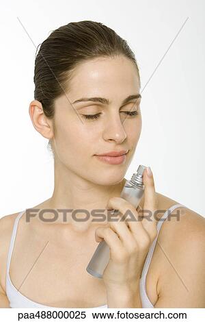 Woman smelling perfume, eyes closed View Large Photo Image Stock Photography - Woman smelling perfume, eyes closed. Fotosearch