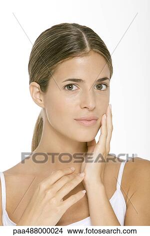 Woman touching cheek, smiling at camera, portrait View Large Photo Image Picture - Woman touching cheek, smiling at camera, portrait. Fotosearch